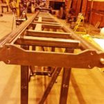 A Section Of Roller Coaster Track Is Test Assembled In A Workshop