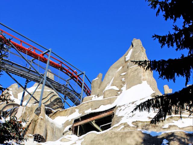 Looking Through Trees At The Track For Canada's Wonderland's "The Guardian" Roller Coaster Cresting Past The Peak Of "Wonder Mountain" Under Construction