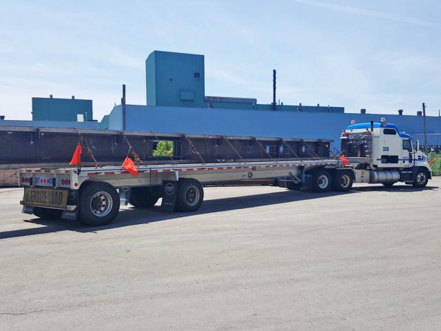Custom Fabricated Structural Steel Support Girders Sit Loaded On A Truck