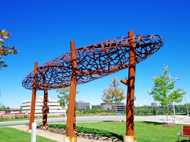 "Summer Clouds" Public Art Sculptures. Rusty Metal Artistic Clouds Suspended Above The Ground By Metal Legs