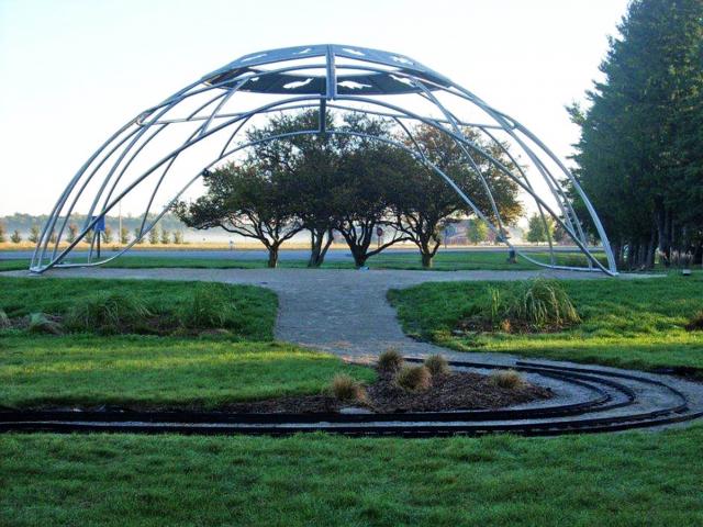 The Sculpture "Wisdom" By Gordon Reeve, Fabricated From A Mesh Of Custom Rolled Stainless Steel Pipe Which Resembles A Circular Playground Climbing Structure