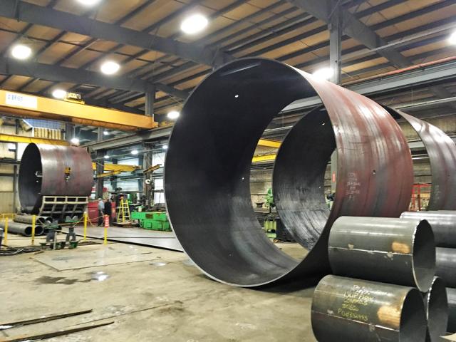 Large Sections Of Plate Steel Have Been Rolled Into Cylinders And Welded For A Mining Industry Elevator Shaft Reline Project