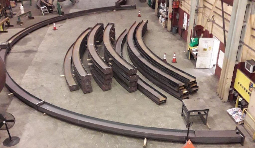 Curved Structural Steel Beams Undergo A Trial Fitting In A Kubes Steel Shop