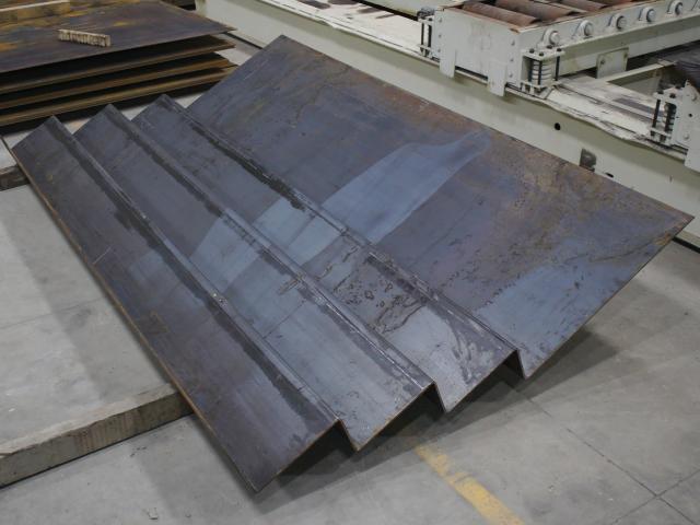 A Completed Set Of Custom Fabricated Staircase Treads Sits In A Kubes Steel Shop