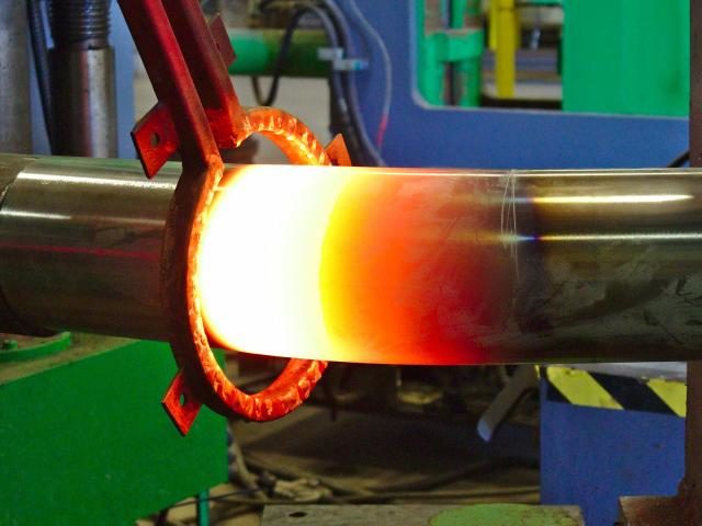 A Section Of Thick Walled Stainless Steel Pipe Is Formed Via Induction Bending