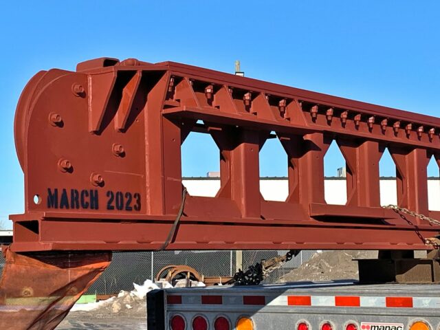 A "Ram Girder." A Long Structural Steel Fabrication With Triangular Openings Loaded Onto A Truck For Shipping