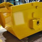 A Custom Fabricated Scrap Handling Bucket Sits In A Workshop