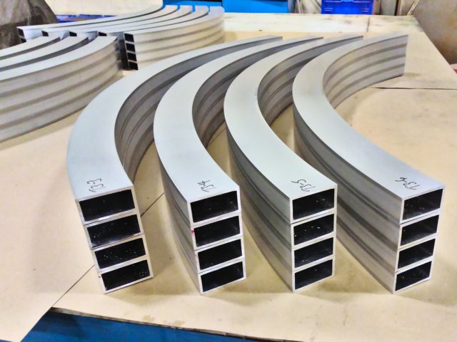 Custom Curved Aluminum Hollow Structural Sections Stacked For Shipping