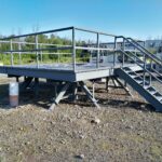 A Custom Fabricated Raised Platform For Part Certification Testing Is Installed In A Yard