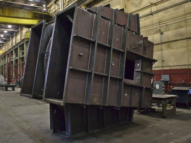 A Custom Fabricated Industrial Fan Housing Featuring Two Duct Connections Under Construction At Kubes Steel