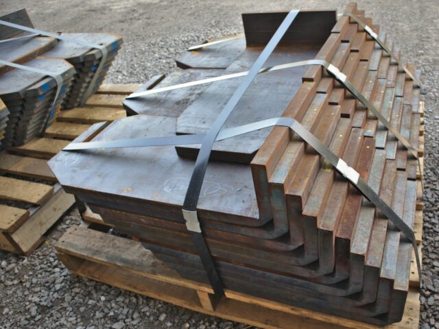 A Stack Of Heavy Plate Sections Formed Via Induction Bending Sits Ready For Shipping At Kubes Steel
