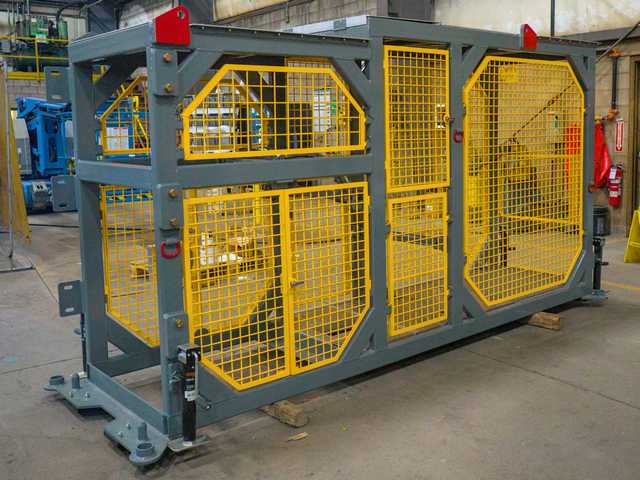 A set of custom fabricated equipment modules for mining sit completed in a workshop.